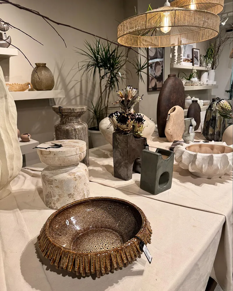 Textured ceramic vases and bowls in neutral earth tones.