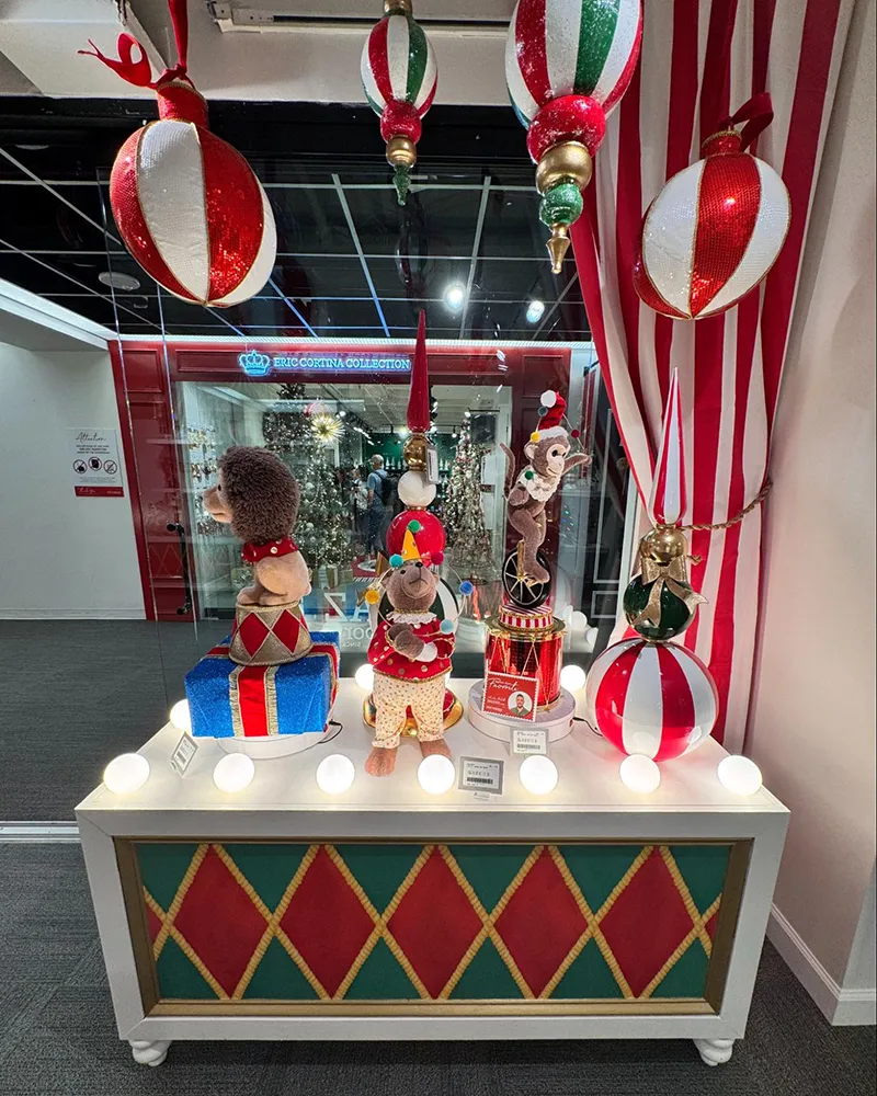 A vintage circus-themed holiday display with animals and red and white stripes, inspiring playful and nostalgic elements in commercial office design trends.