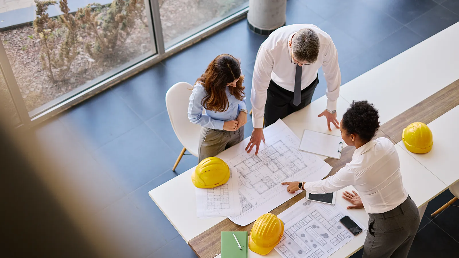 Experts from interior landscape companies collaborating with architectural firms on early-stage building plans.