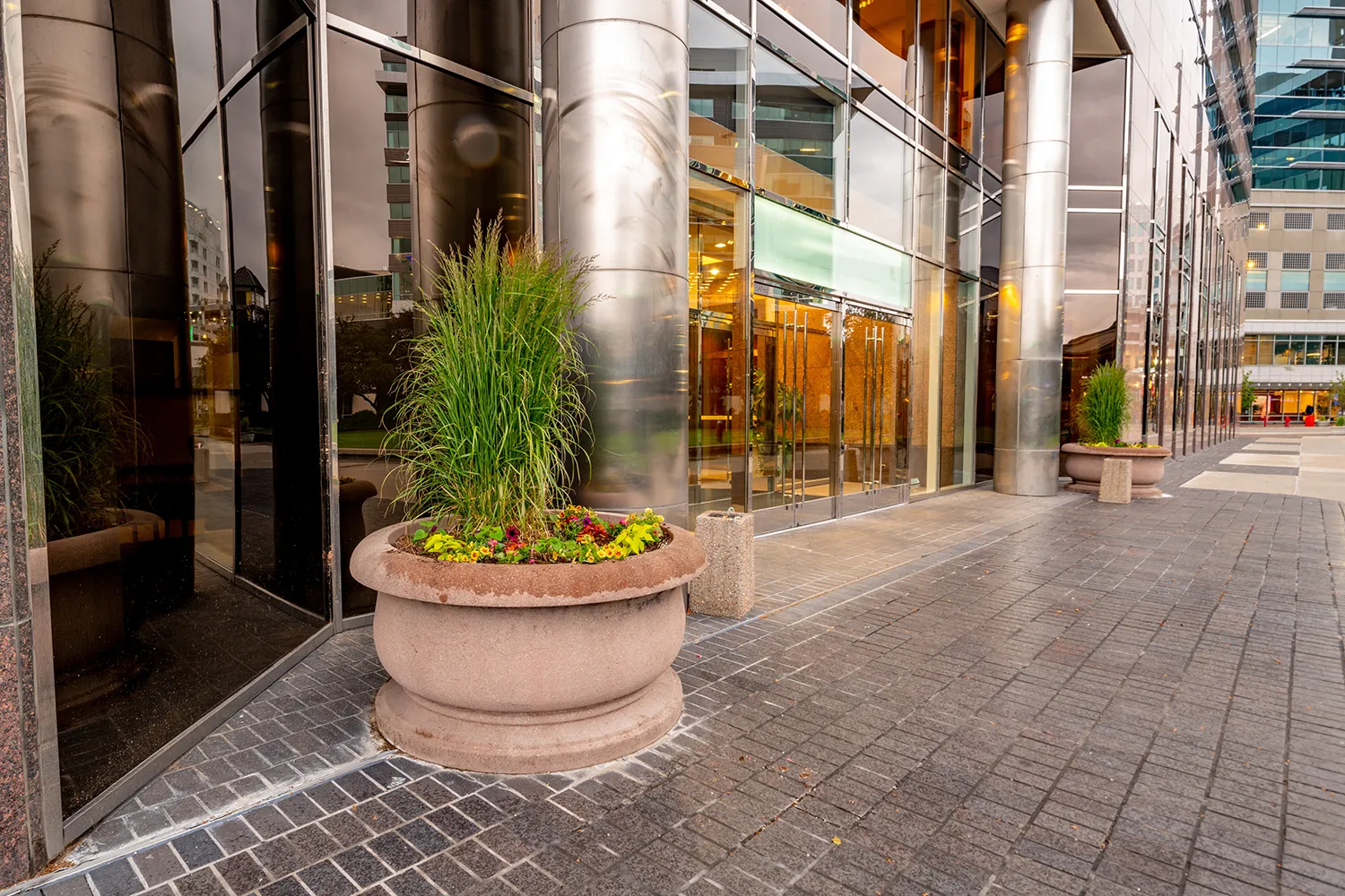 Commercial outdoor planters at a Chicago hotel entrance with layered summer foliage