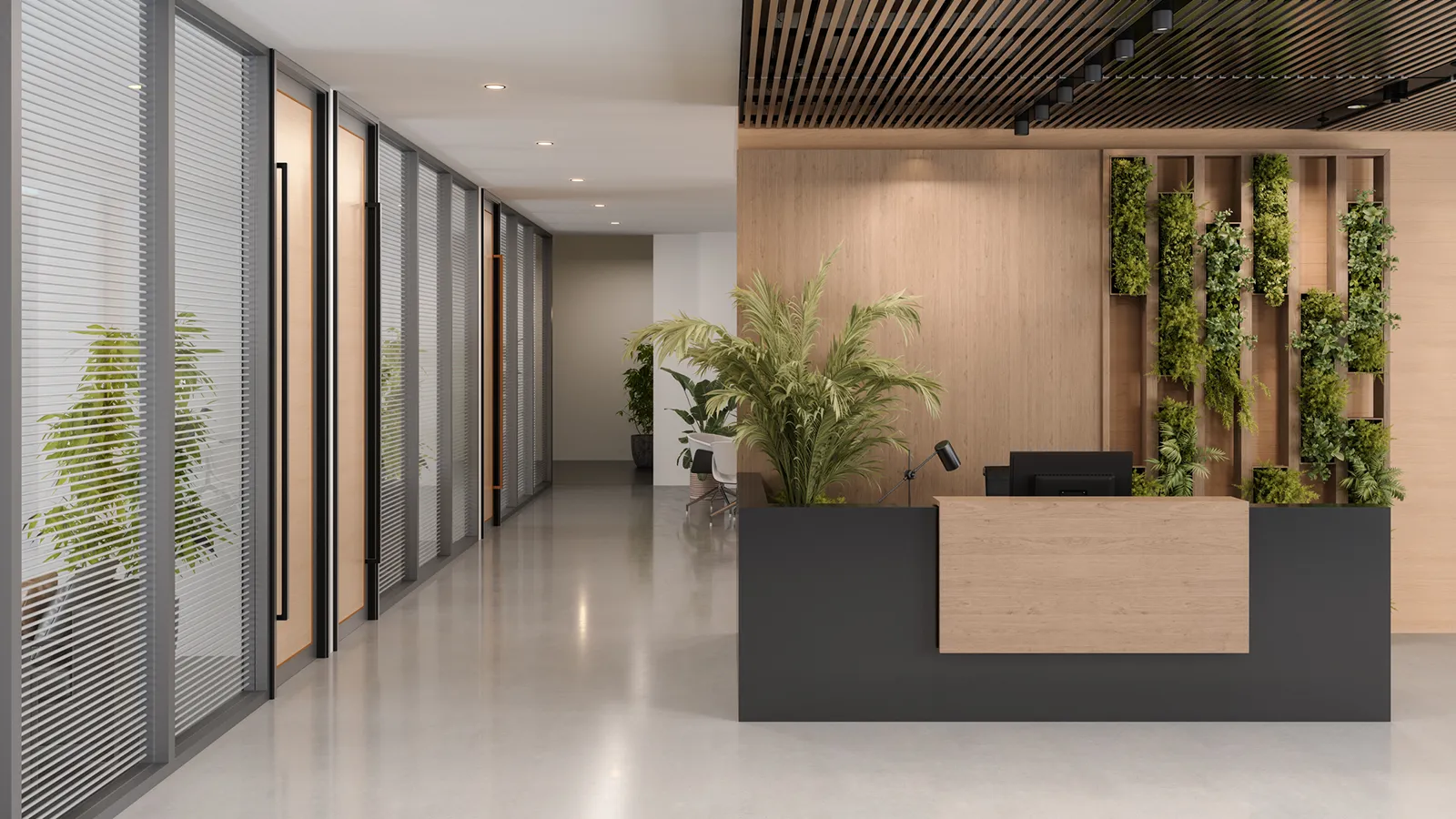 Modern commercial reception area with a reception desk, decorative indoor plants, and marble flooring.